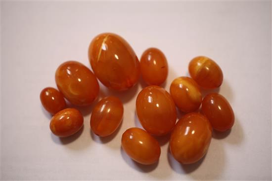 A double strand graduated oval amber bead necklace, gross weight 104 grams.